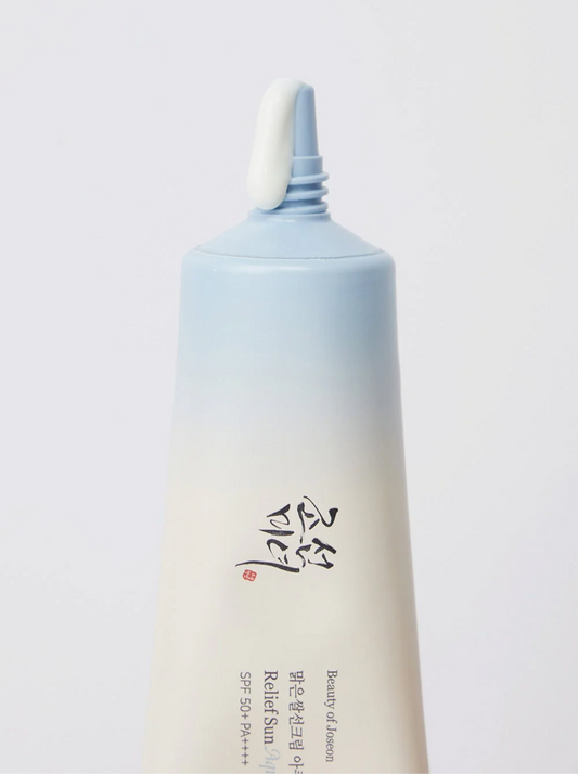 Skincare bottle with gradient design on a light gray background