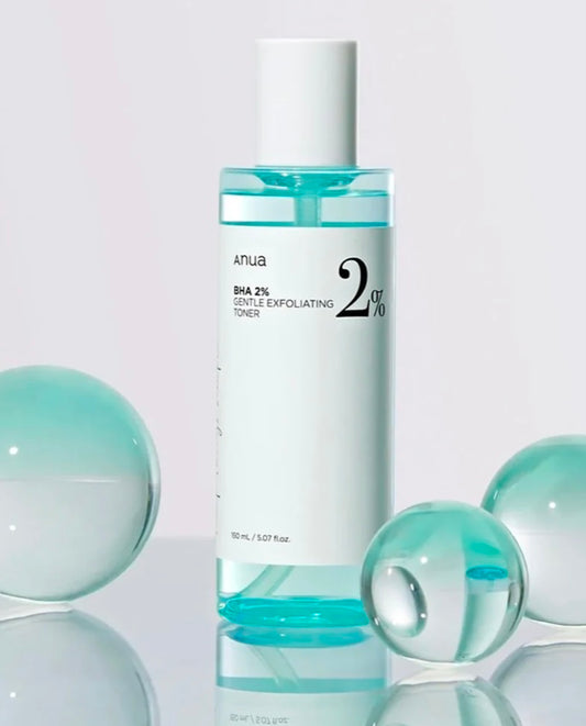 The clear, water-like texture of the Anua BHA gentle exfoliating toner on cotton pad.