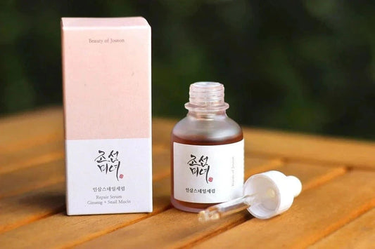 Beauty of Joseon Revive Serum (ginseng + snail mucin) bottle with box on a wooden surface