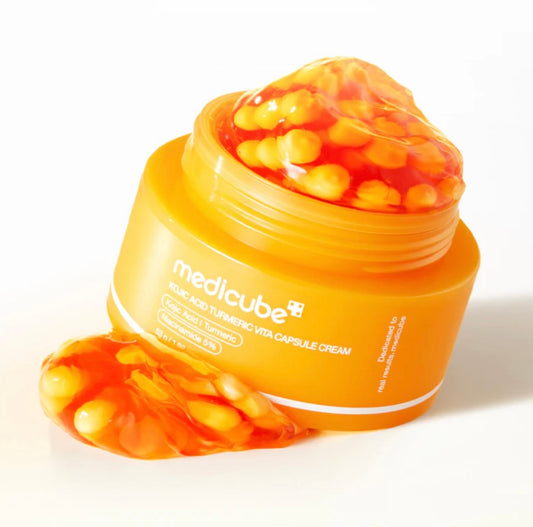 Close-up showing the yellow turmeric & kojic acid capsules mixed with the hydrating orange gel