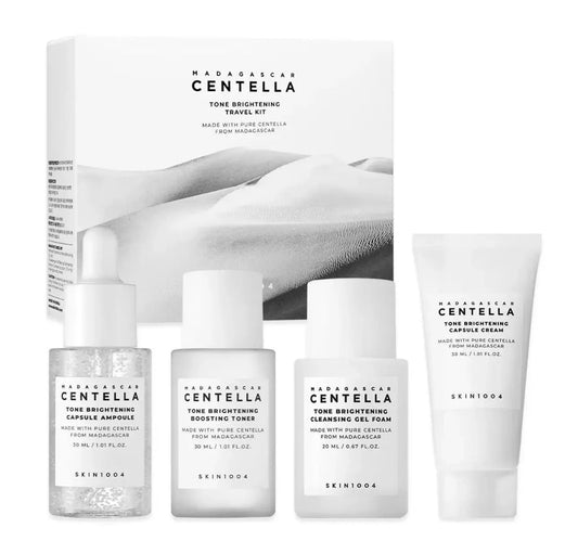 SKIN1004 Madagascar Centella Tone Brightening Travel Kit featuring cleansing gel foam, boosting toner, capsule ampoule, and capsule cream in travel sizes