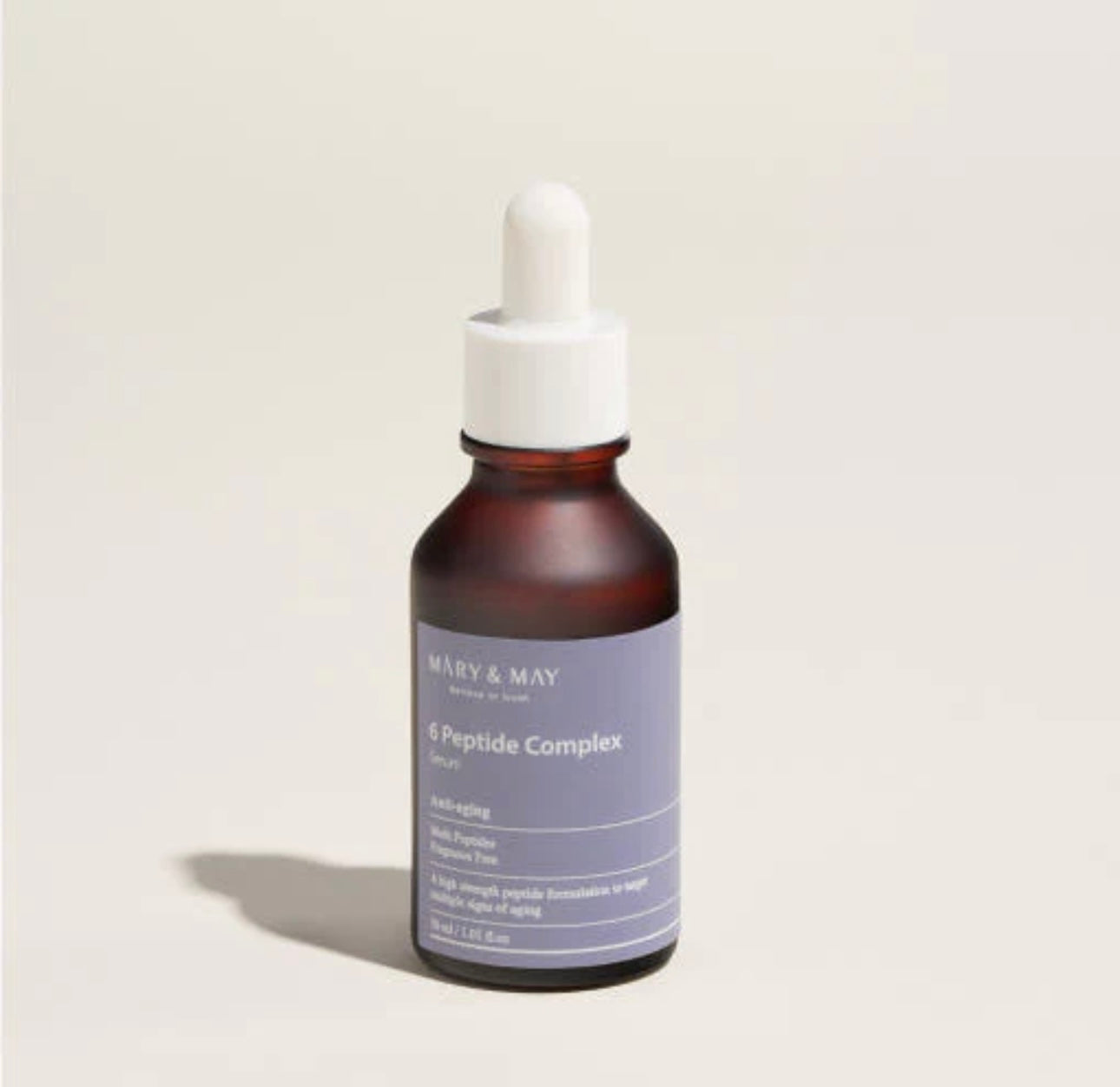 Applying the Mary and May 6 peptide serum onto fingertips for a gentle facial massage.