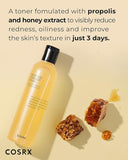 Cosrx toner bottle with propolis and honey extract on a beige background