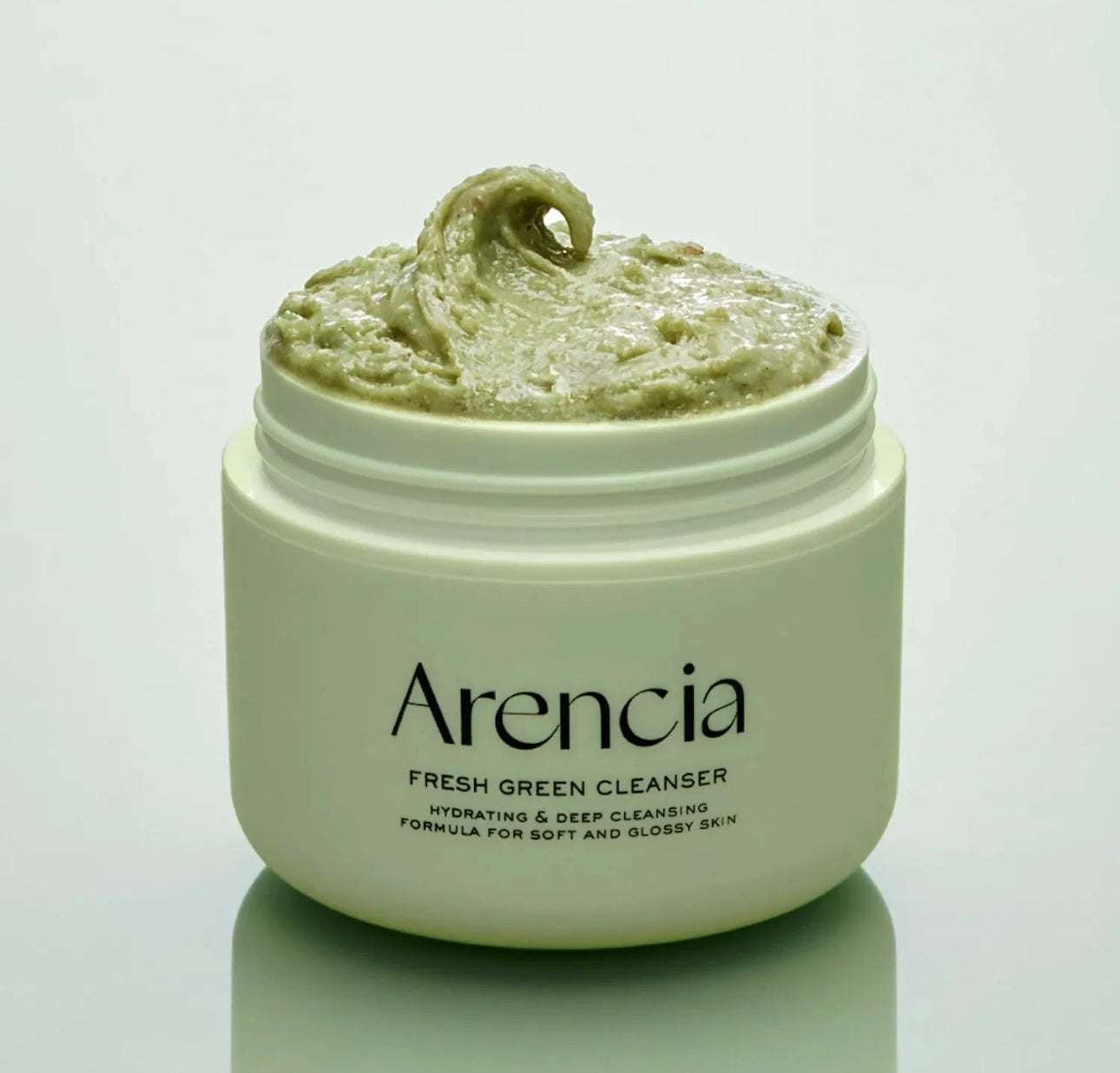 Close-up of the ARENCIA Mochi Cleanser's texture and green rice particles.