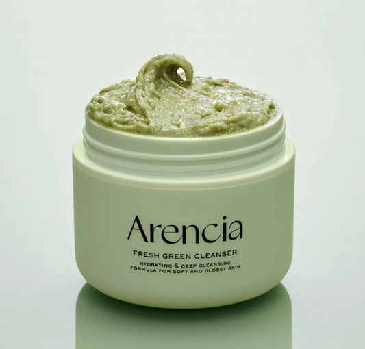 Close-up of the ARENCIA Mochi Cleanser's texture and green rice particles.