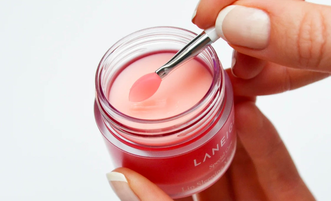 Laneige lip sleeping mask berry jar next to its applicator.