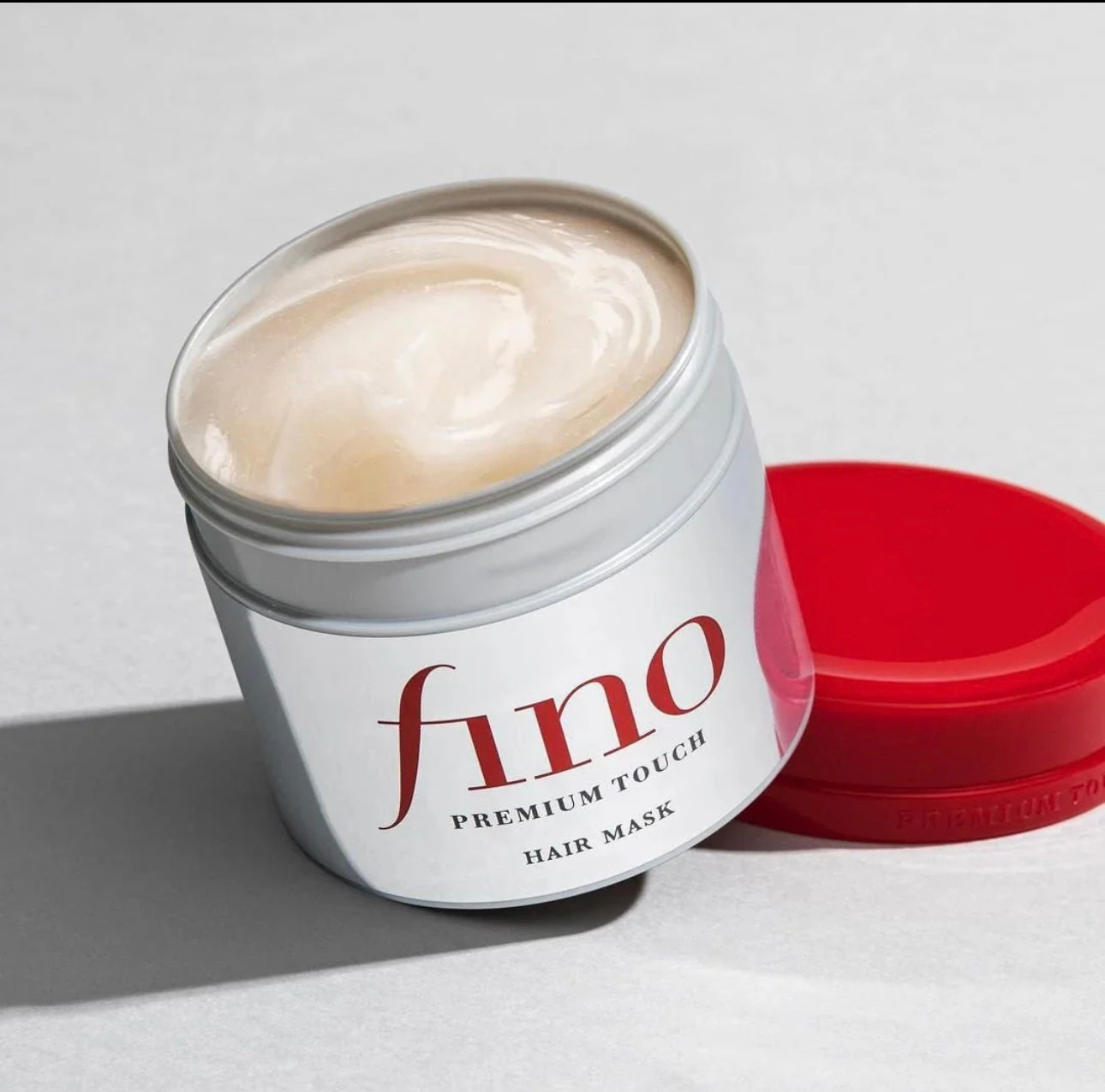 Open jar of Shiseido Fino hair mask showing rich creamy texture
