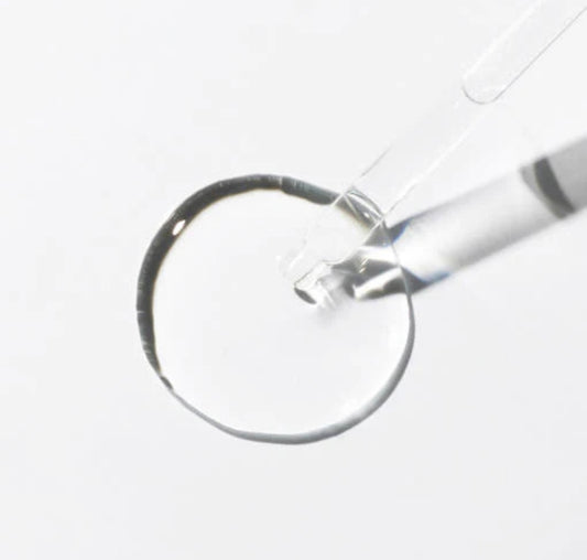 Close-up of the 6 peptide serum's lightweight, easily absorbable texture on the dropper.