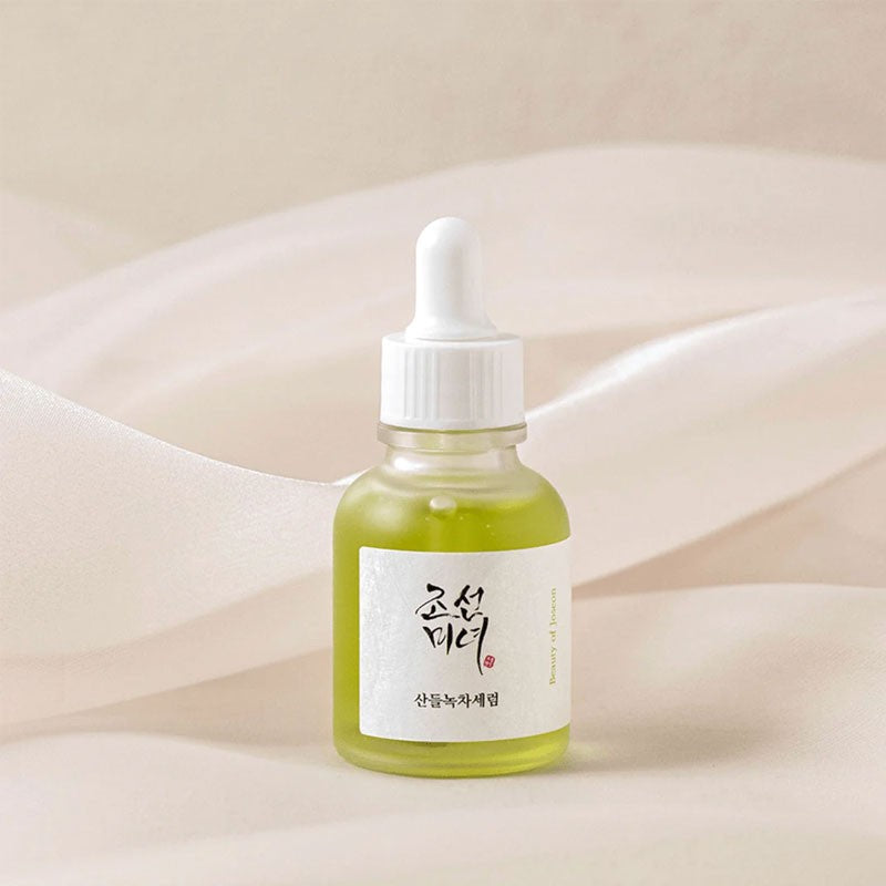 Applying the BOJ green tea serum to calm and hydrate sensitive skin, gently massaging the calming serum.
