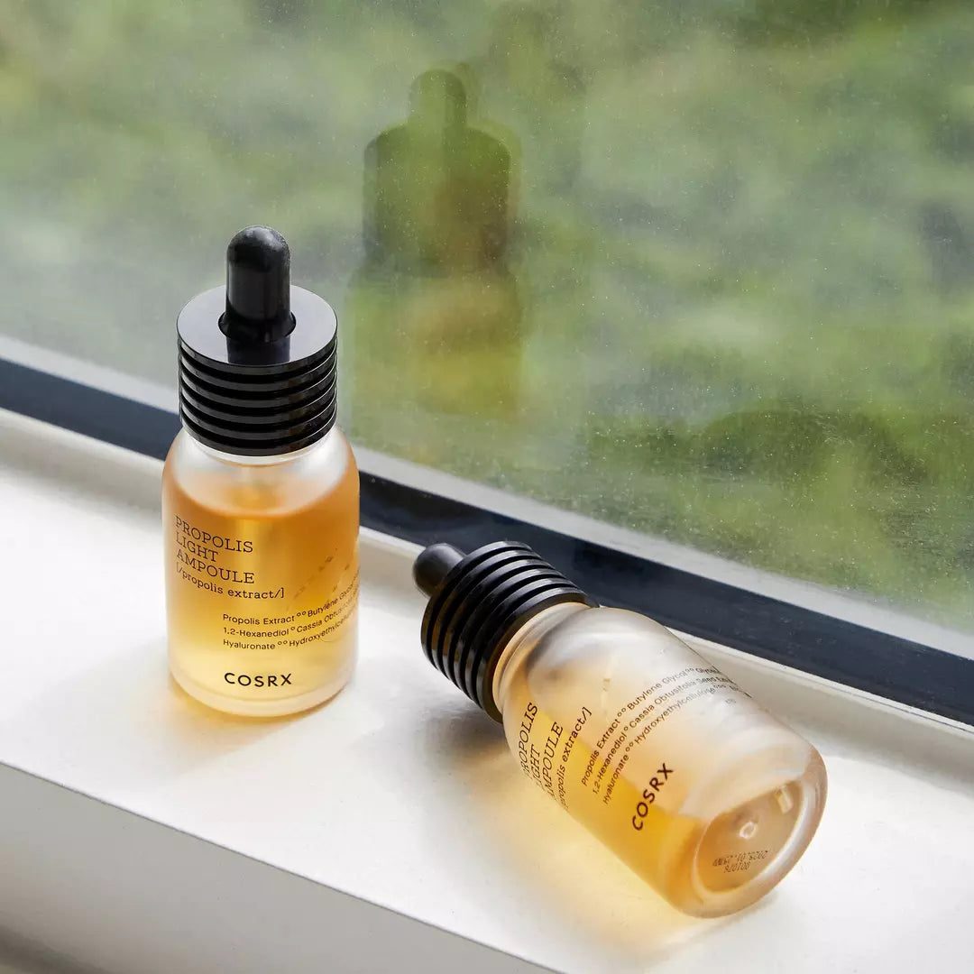 Applying COSRX Full Fit Propolis Light Ampoule - Gently massaging 2-3 drops of this moisturizing ampoule for elasticity and radiance.