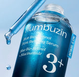 Woman gently applying the Numbuzin No. 3 serum to her cheek for pore care.