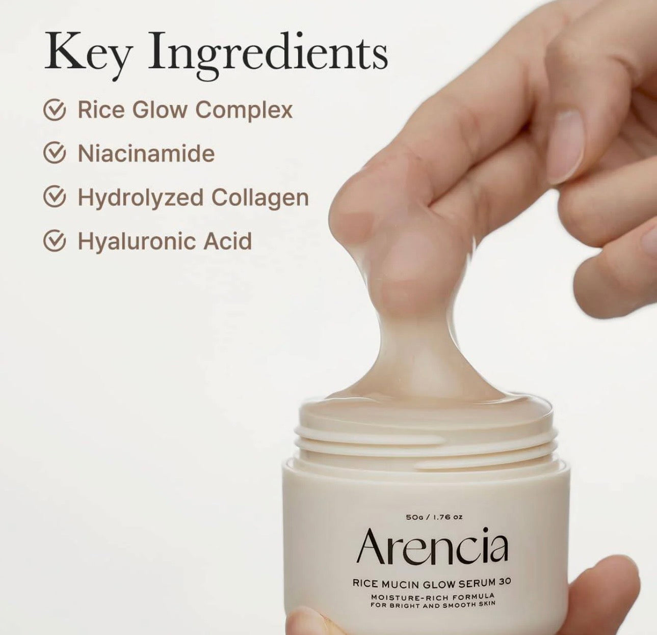 Flat lay of Arencia rice mucin glow overnight serum 30 surrounded by raw rice grains and a soft white towel.