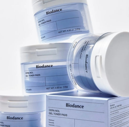 A single, hydrating Biodance gel toner pad being gently lifted from the jar.