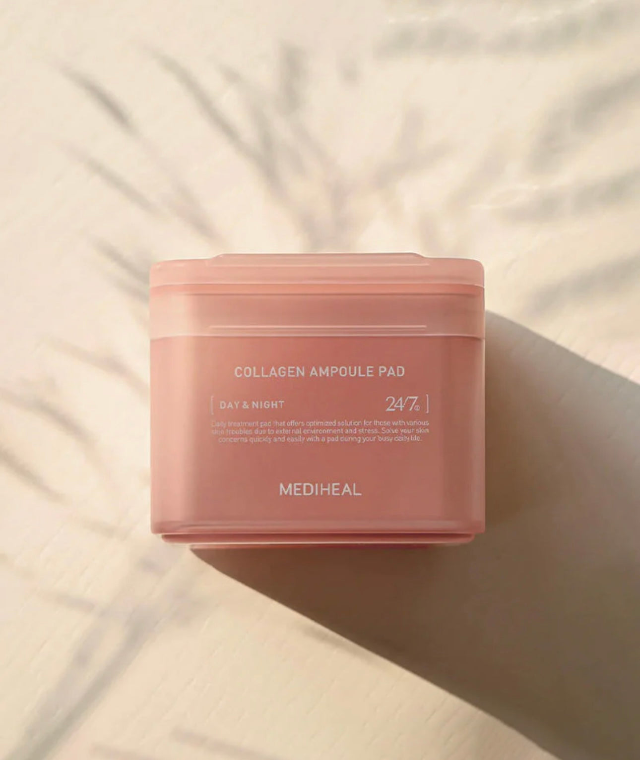 Close up of a Mediheal collagen ampoule pad saturated in hydrating, milky collagen essence.
