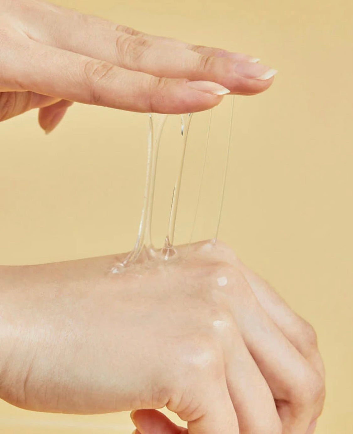 Clear, lightweight texture of COSRX snail mucin essence on skin — shows fast-absorbing, non-greasy finish.