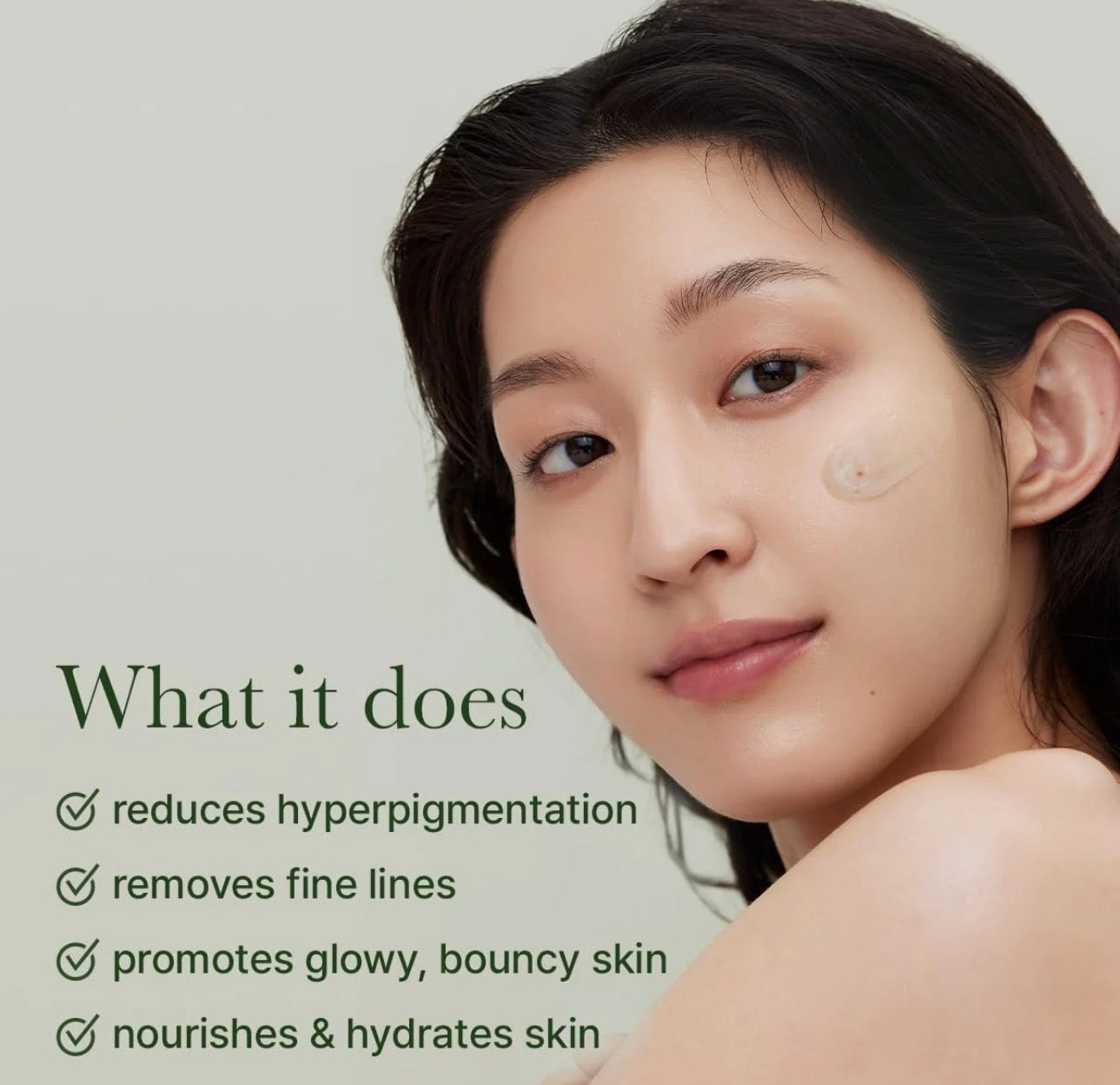 A drop of holy hyssop serum on fingertip showing the lightweight, easily absorbed gel texture