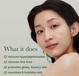 A drop of holy hyssop serum on fingertip showing the lightweight, easily absorbed gel texture