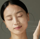 Jumiso Snail Mucin 95 Peptide Facial Essence applied on hand showing smooth serum texture