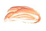 Smeared peach-colored cream on a white background