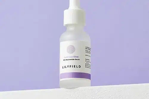 Applying LILYFIELD Luminous Glow Serum to face and neck
