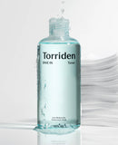 A drop of Torriden low molecular hyaluronic acid toner on the back of a hand, showing its lightweight, water-like consistency.