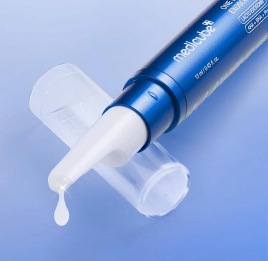 Close up of clear lightweight One Day Exosome Shot Pore Ampoule serum dropping from glass pipette.