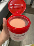 Model with clear skin holding Medicube Red Succinic Acid Peeling Pads — helps reduce pores and post-acne marks