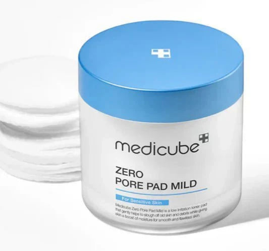 Soaked Medicube pore pad mild on fingertips, showing essence-rich zero pore mild pad texture.