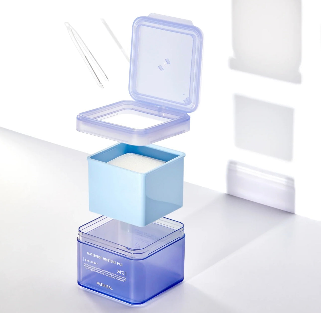 Open jar of Mediheal Watermide Pore Tightening Essence Pad with built-in tweezers for easy hygiene.