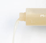 Close up texture of super glowing essence toner by numbuzin, showing the rich fermented formula with bifida and rice ferment for nourishment.