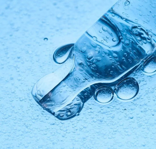 Close-up of the Numbuzin pore serum's lightweight, blue-tinted texture on a dropper