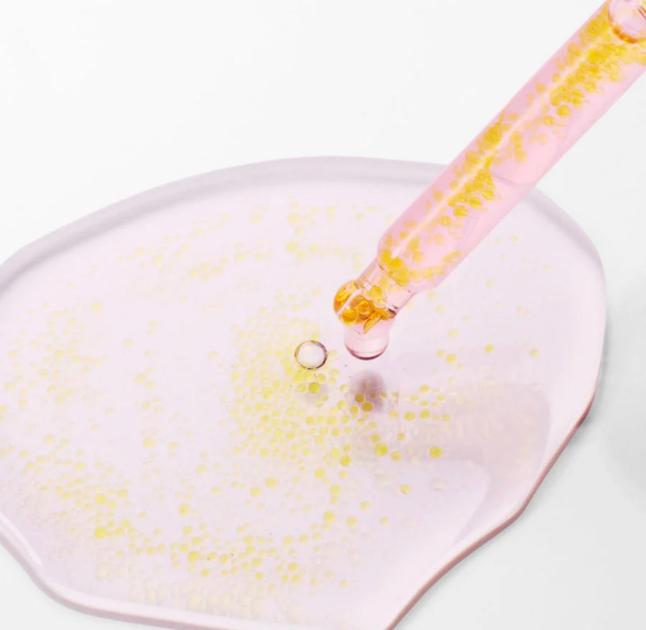 Close-up of the dropper from the Purito TXA 6 Niacinamide 10 serum dispensing a drop.