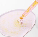 Close-up of the dropper from the Purito TXA 6 Niacinamide 10 serum dispensing a drop.