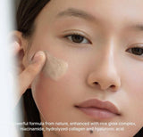 Model patting rice mucin glow overnight serum 30 onto cheeks in a soft evening skincare routine.