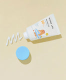 Applying Round Lab Baby Mild Sun Cream SPF 50 PA on baby's cheek