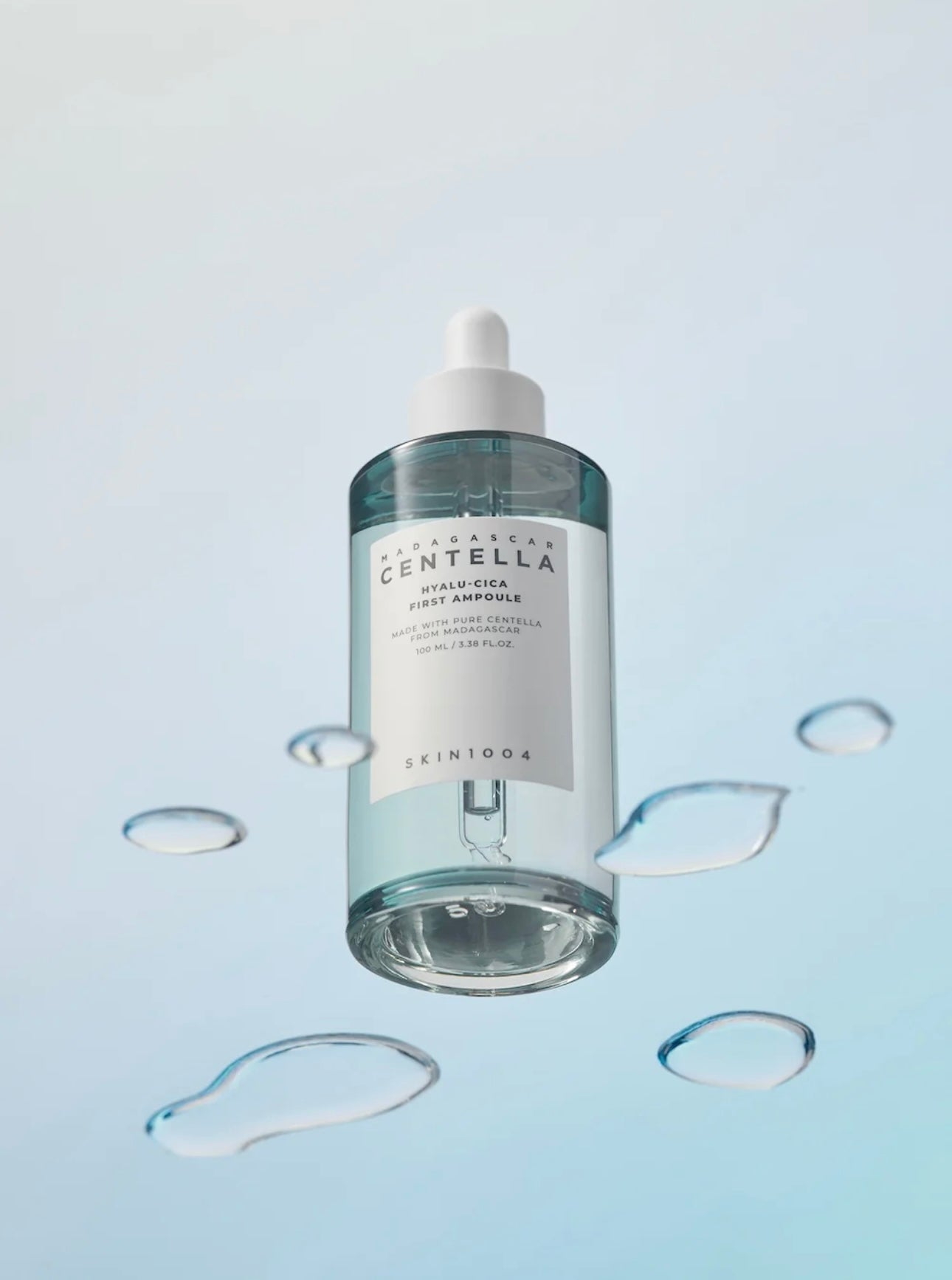Applying SKIN1004 Hyalu Cica ampoule evenly onto glowing skin, promoting absorption and radiance