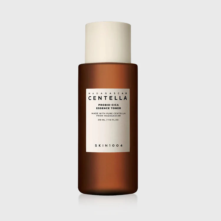 Lifestyle shot: SKIN1004 Madagascar Centella Probio Cica Essence Toner 210ml on bathroom shelf — calm, everyday skincare for sensitive skin.