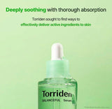 Person gently applying the soothing Torriden serum to their face.