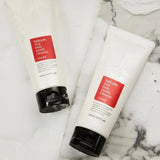 Woman using COSRX Salicylic Acid Daily Gentle Cleanser to wash her face and fight acne